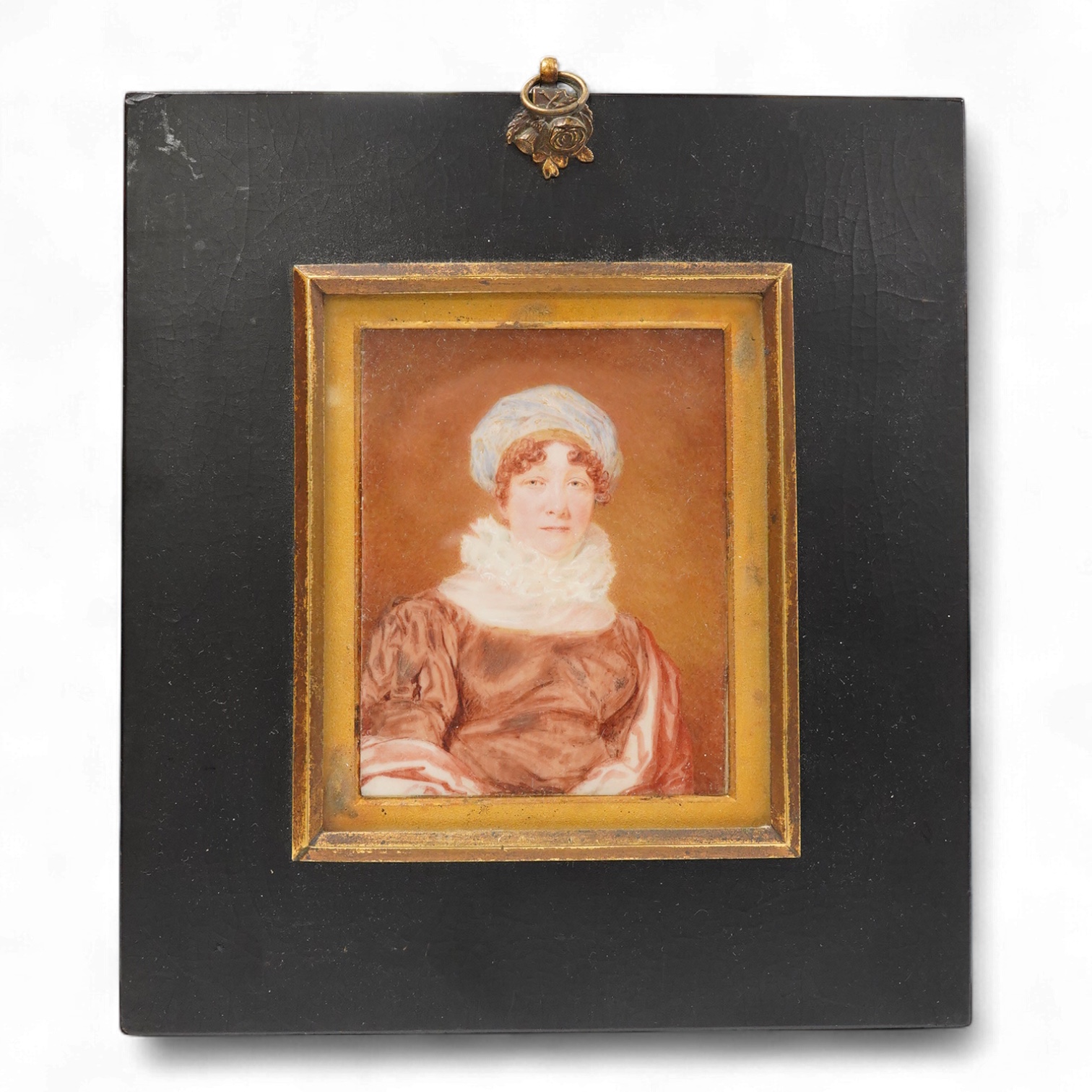 Regency School, Portrait miniature of a lady wearing a bonnet, indistinctly inscribed and dated 1822 verso, watercolour on ivory, housed in an ebonised frame, 9.5 x 7.5cm CITES Submission reference EL8U6S7D